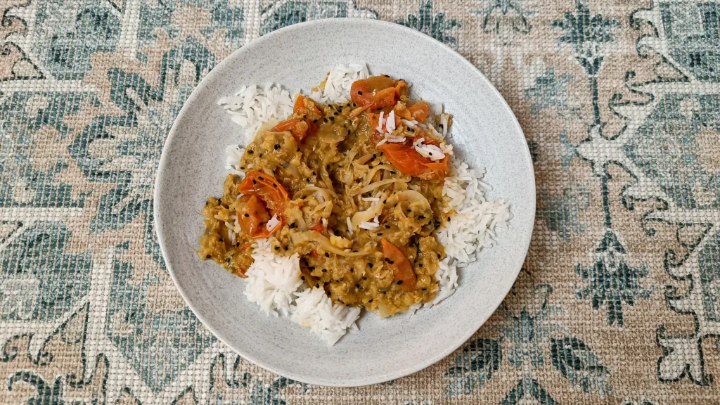 Photograph of All-in-one nigella-spiced whole tomato dhal.