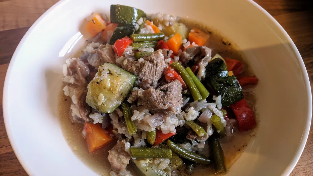 Photograph of Baked lamb, vegetables and rice.