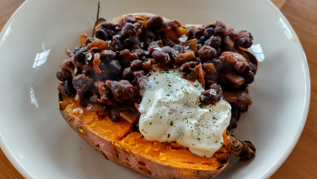 Photograph of Baked sweet potato with easy black bean chilli.
