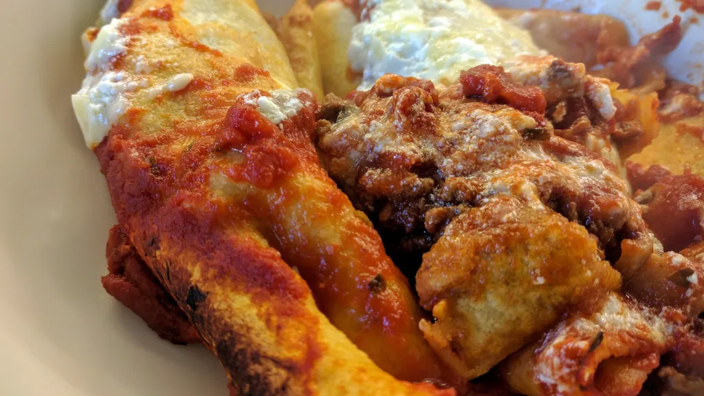 Photograph of Beef enchilada with sweetcorn and avocado salsa.