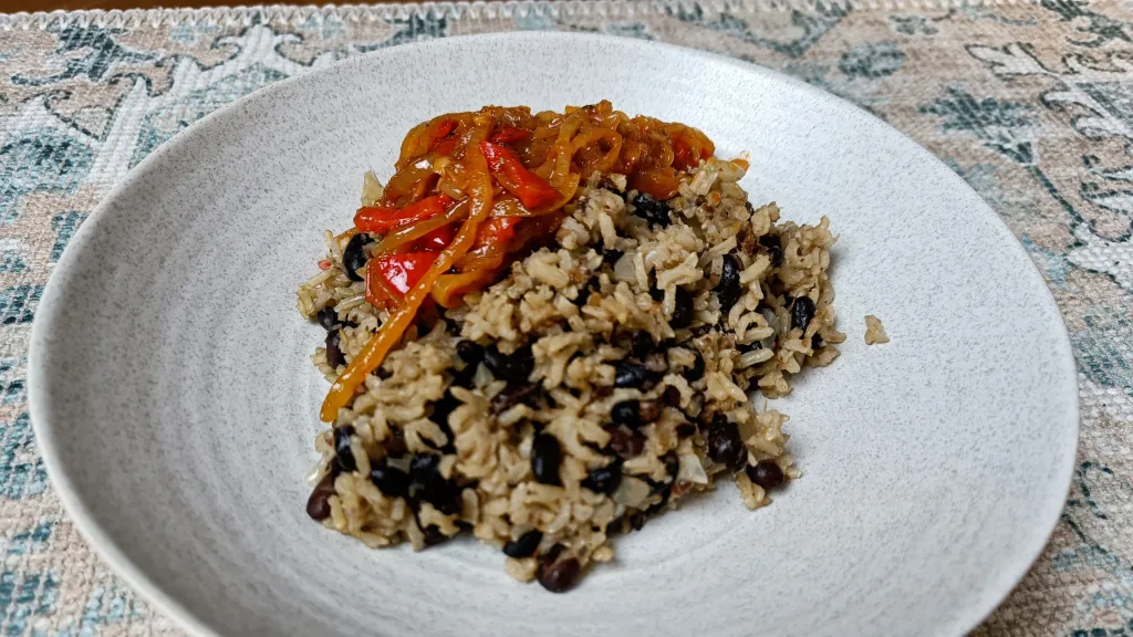 Photograph of Black beans and rice with jammy peppers.