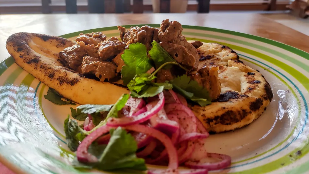 Photograph of Black lime beef skewers with sumac onions.