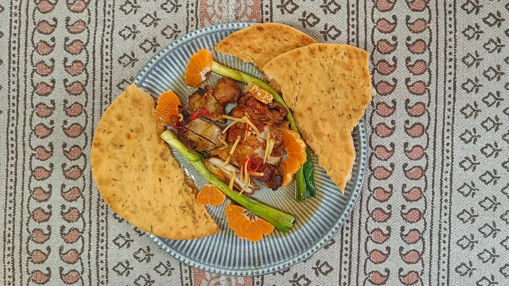 Photograph of Blackened chicken with caramel and clementine dressing.