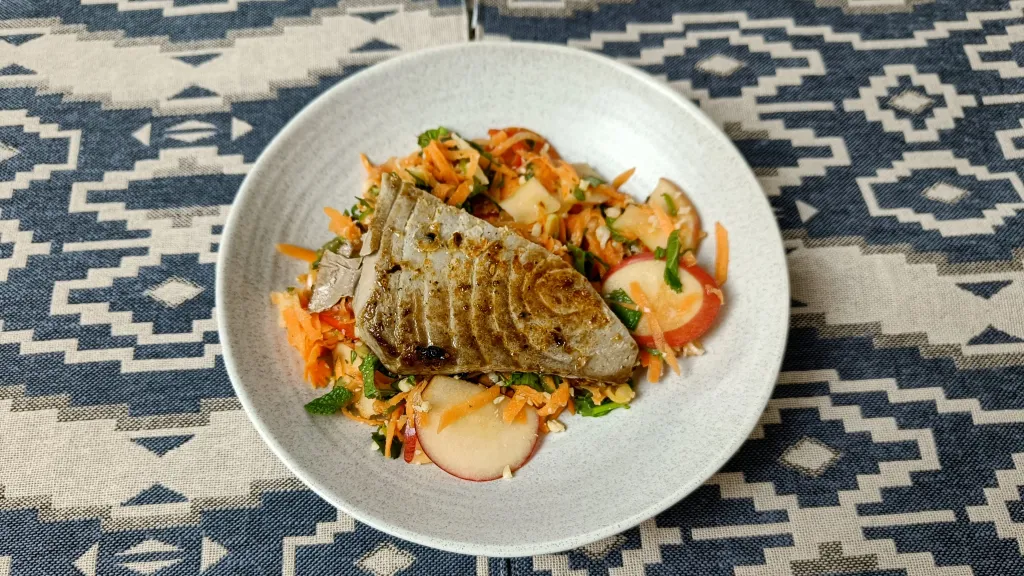 Photograph of Carrot, apple & black pepper salad with seared tuna.