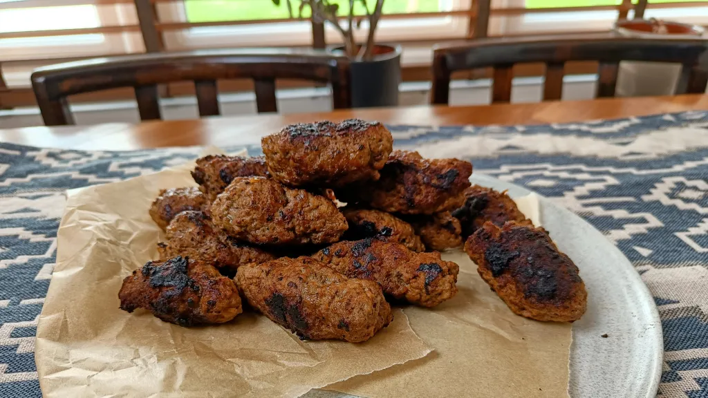 Photograph of Cevapi (southeastern european meat and onion sausages).