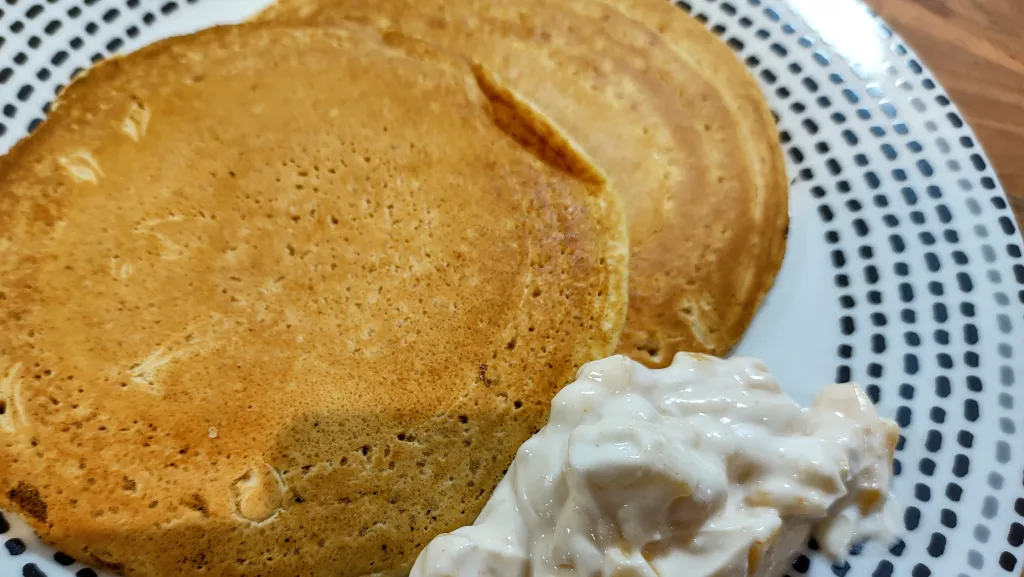 Photograph of Chickpea pancakes with mango pickle yoghurt.