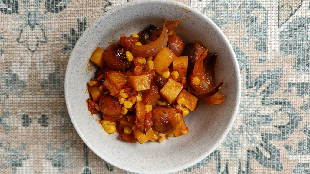 Photograph of Chorizo, potato, sweetcorn, tomato & onion traybake.