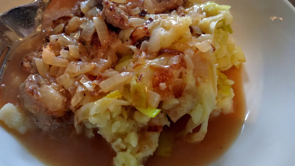Photograph of Cider sausages with leek and potato mash.