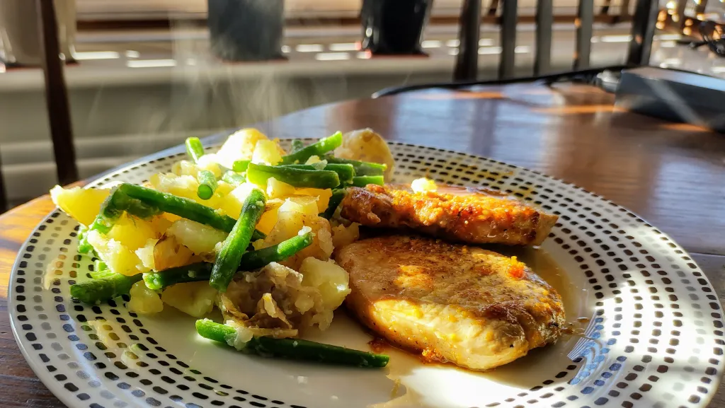 Photograph of Citrus pepper pork with crushed potatoes.
