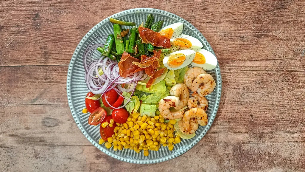 Photograph of Cobb salad with mango and lime dressing.