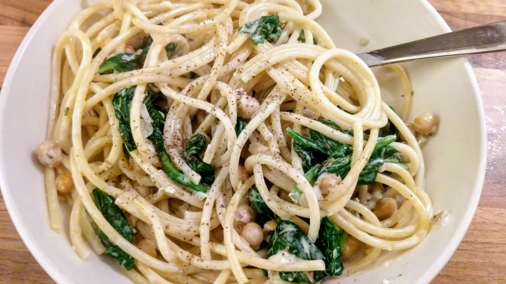 Photograph of Creamy chickpea pasta with spinach and rosemary.