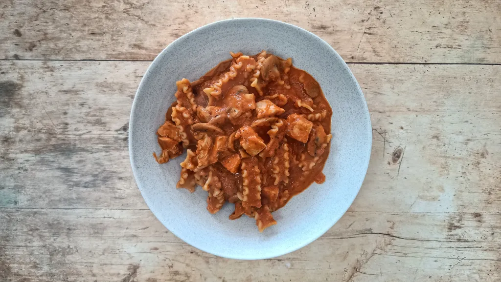 Photograph of Creamy roasted red pepper and chicken pasta.