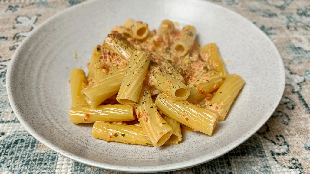 Photograph of Creamy roasted red pepper rigatoni pasta.