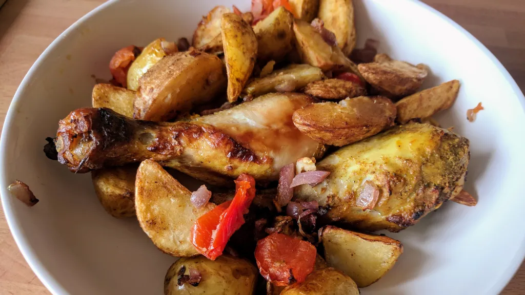 Photograph of Curried chicken & new potato traybake.
