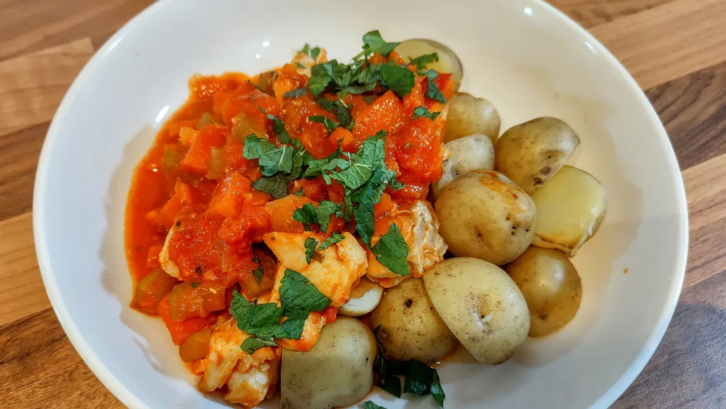 Photograph of Fish tagine with preserved lemon and mint.