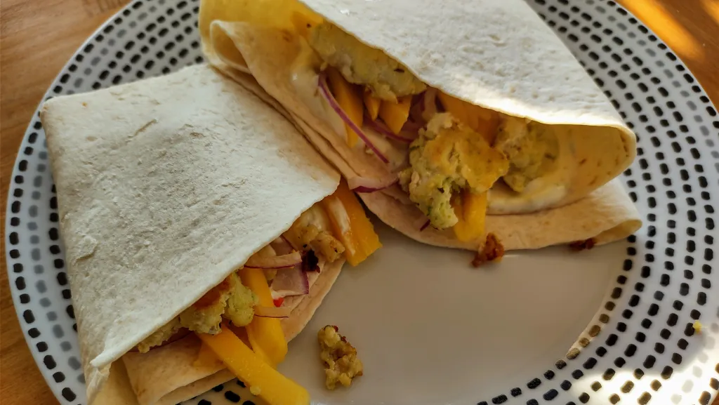 Photograph of Fishcake tacos with mango, lime and cumin yoghurt.