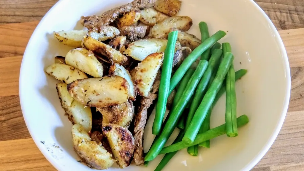 Photograph of Garlic butter steak and potatoes skillet.