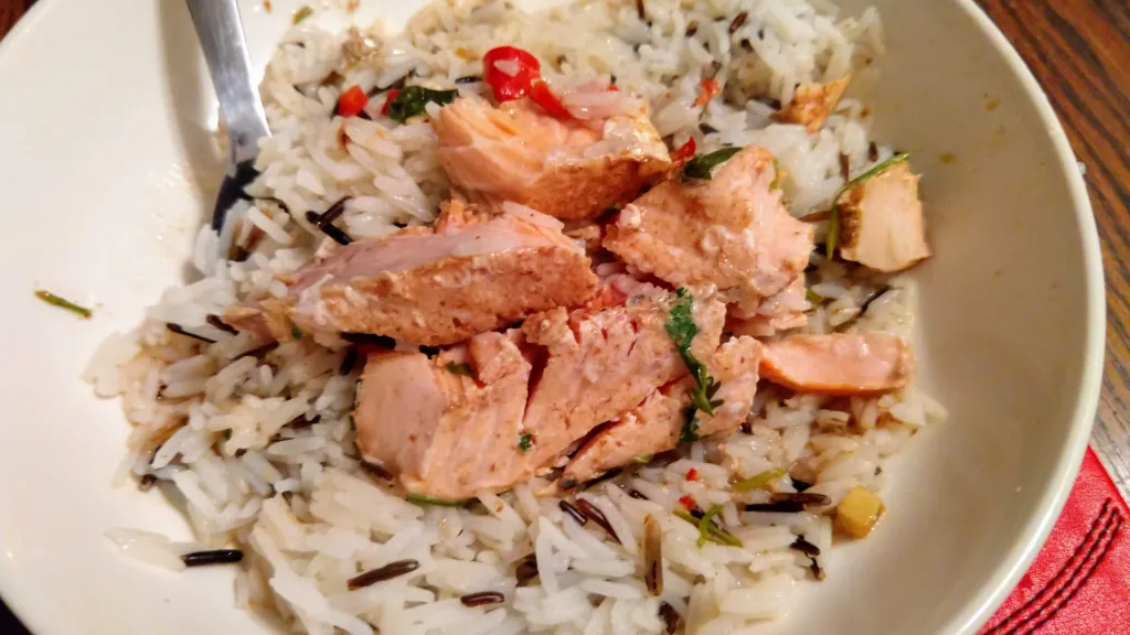 Photograph of Ginger steamed salmon with wild rice.
