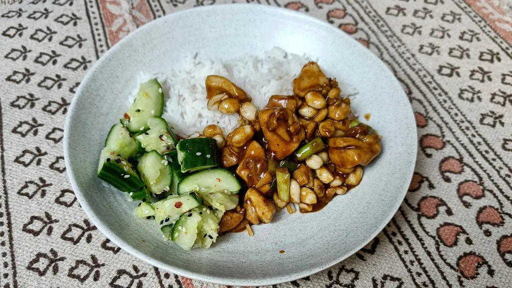 Photograph of Gong bao chicken with smashed cucumber salad.