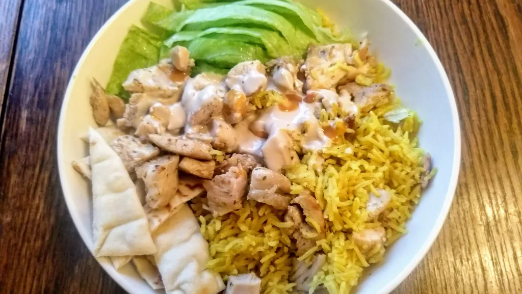 Photograph of Halal cart-style chicken and rice with white sauce.