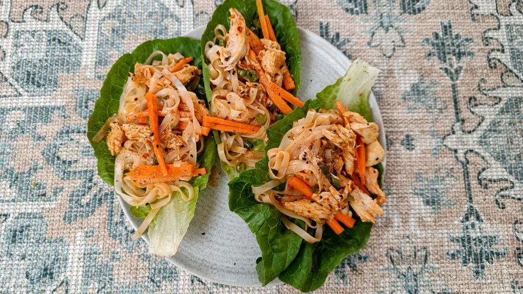 Photograph of Harissa chicken noodle lettuce cups.