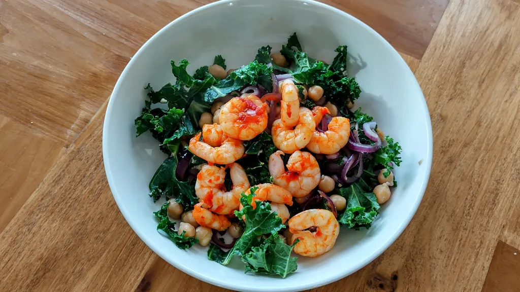 Photograph of Harissa prawns with warm chickpea salad.
