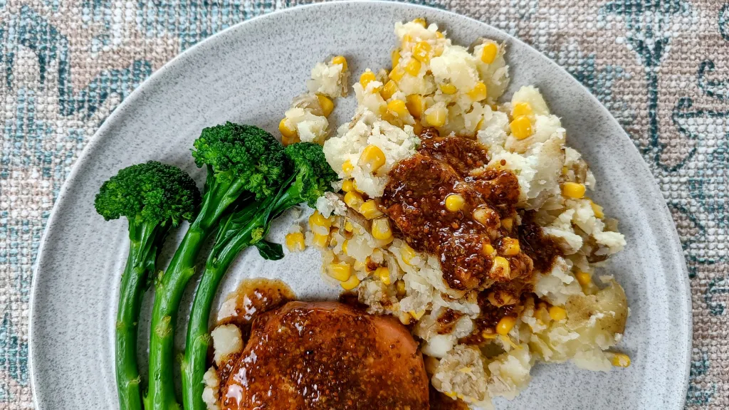 Photograph of Honey-mustard bacon steaks with sweetcorn crush.