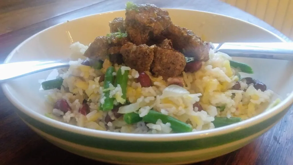 Photograph of Jerk pork with mango and bean rice.