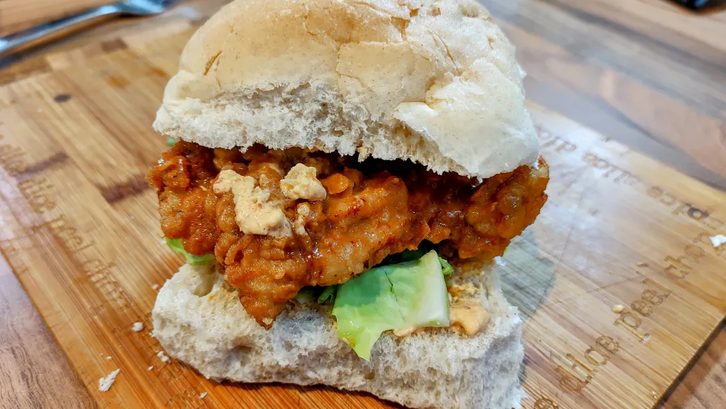 Photograph of Kimchi-brined fried chicken sandwich.
