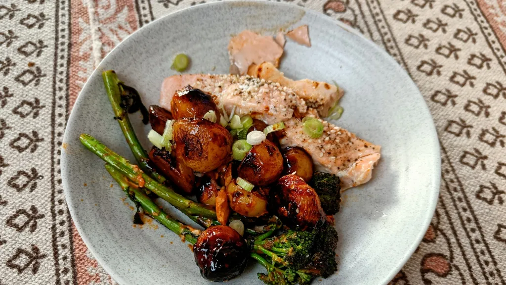 Photograph of Korean-style roast salmon, sweet and spicy potatoes & tenderstem broccoli.
