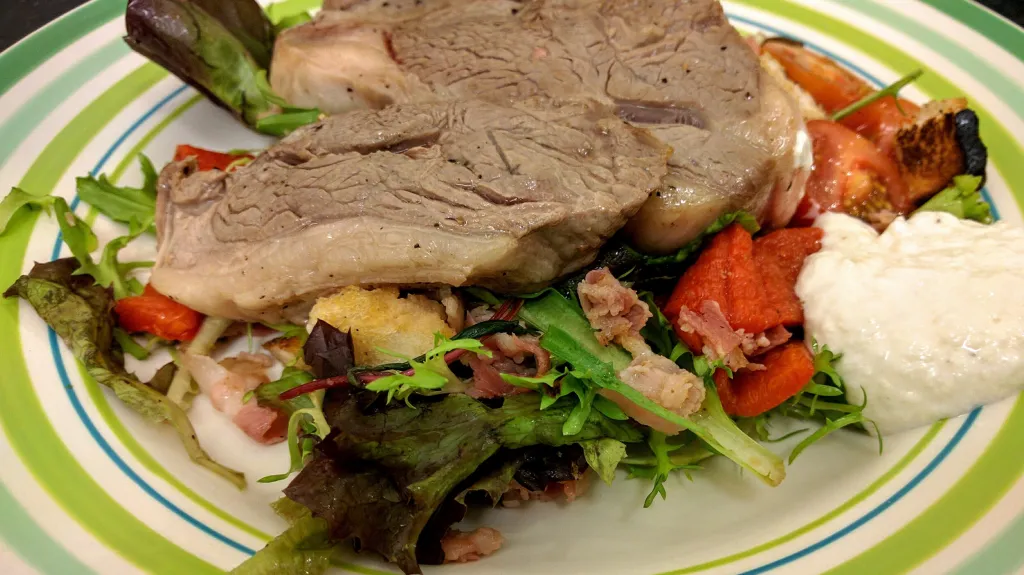 Photograph of Lamb chops with pancetta salad & yoghurt dressing.