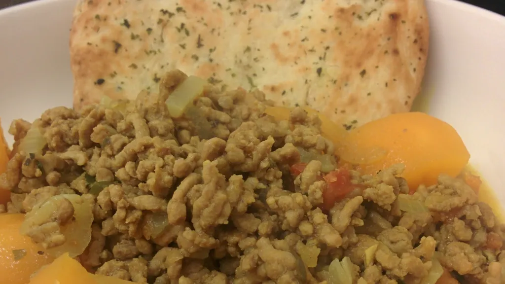 Photograph of Lamb kheema with naan bread.