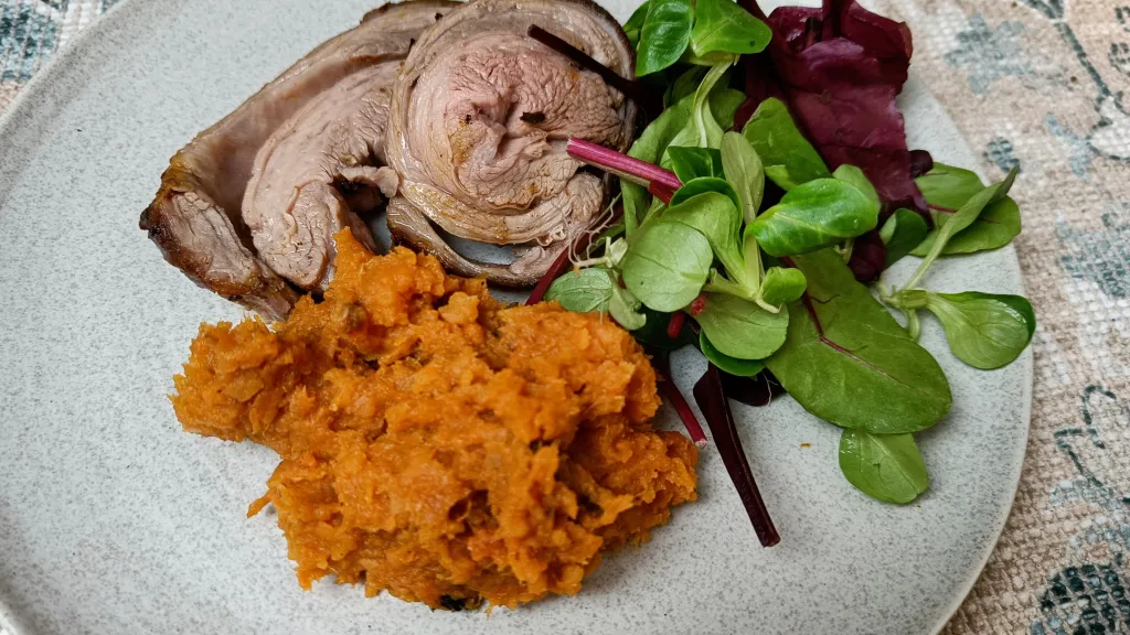 Photograph of Lamb loin with harissa and sweet potato mash.