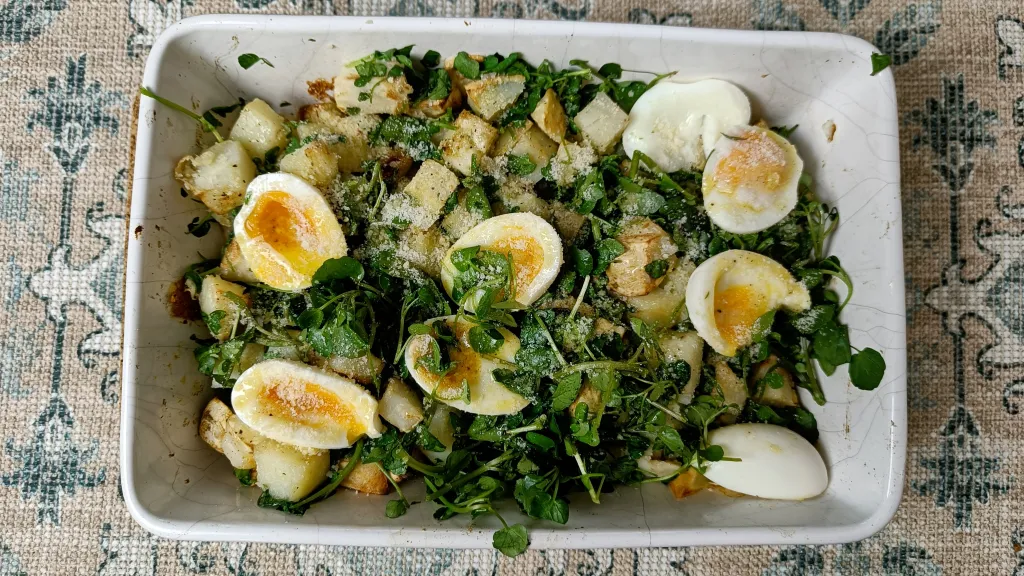 Photograph of Lux warm winter salad: roasted potatoes & celeriac with truffle & soft-boiled eggs.