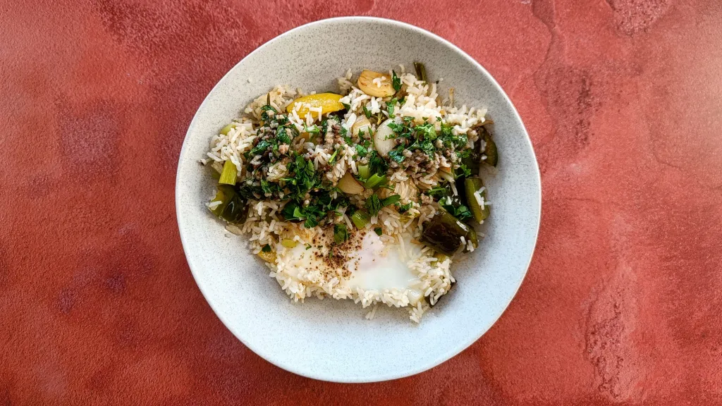 Photograph of Mediterranean style fried rice with anchovy dressing.