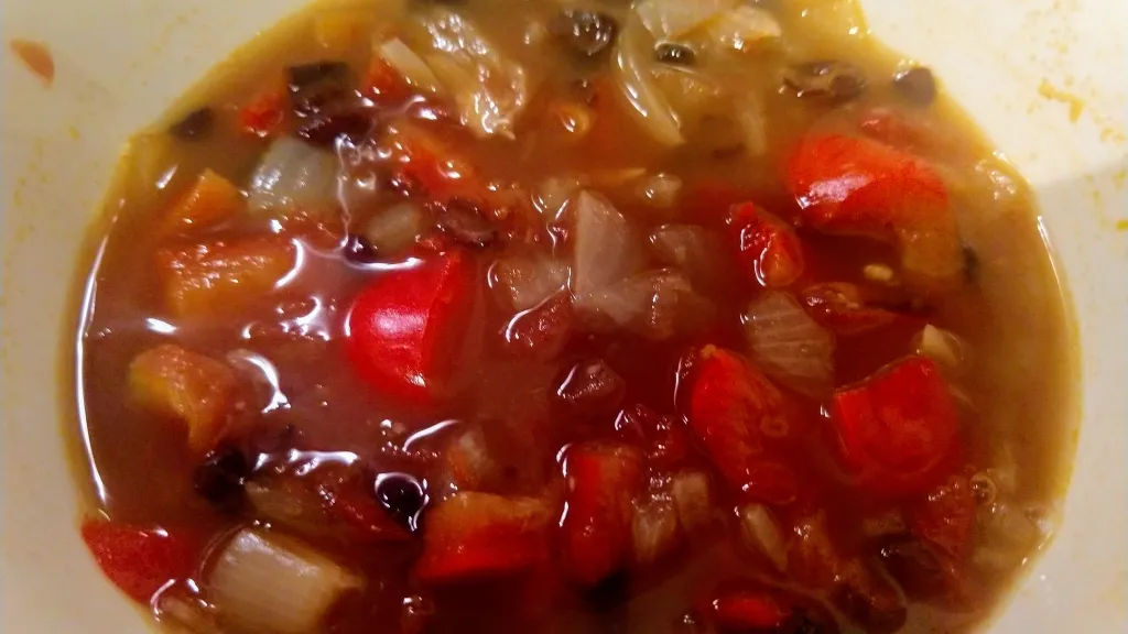 Photograph of Mexican bean soup with guacamole.