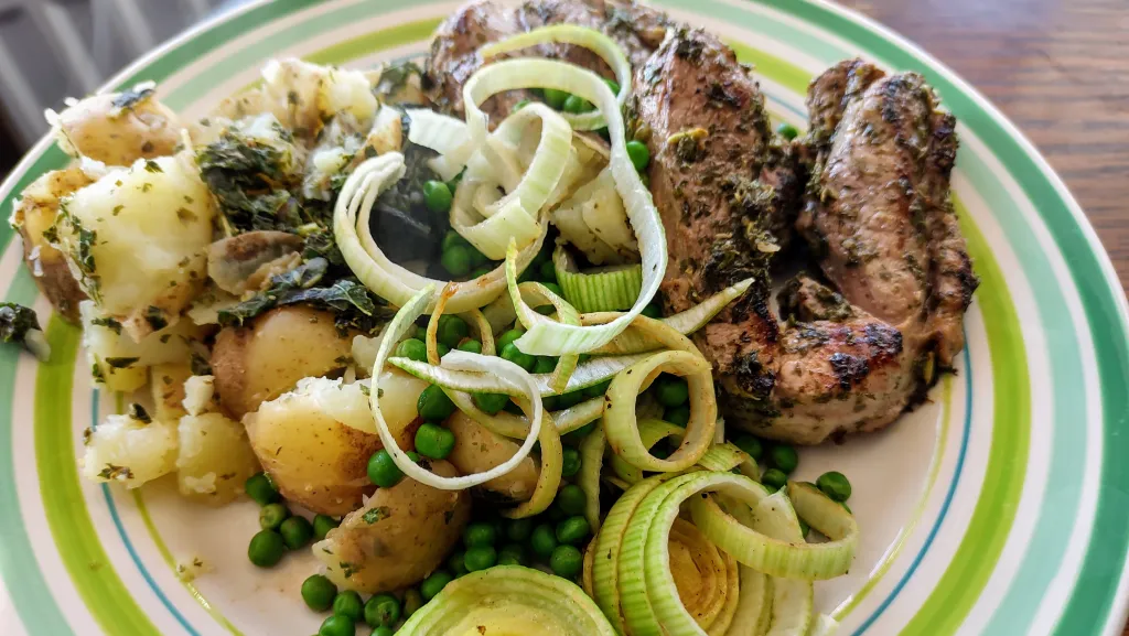 Photograph of Minty salsa verde lamb with lemony potatoes and leeks.