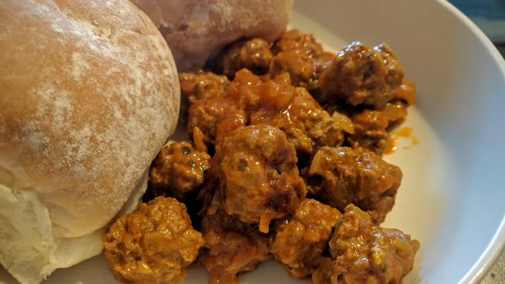 Photograph of Moroccan meatball tagine with lemon & olives.