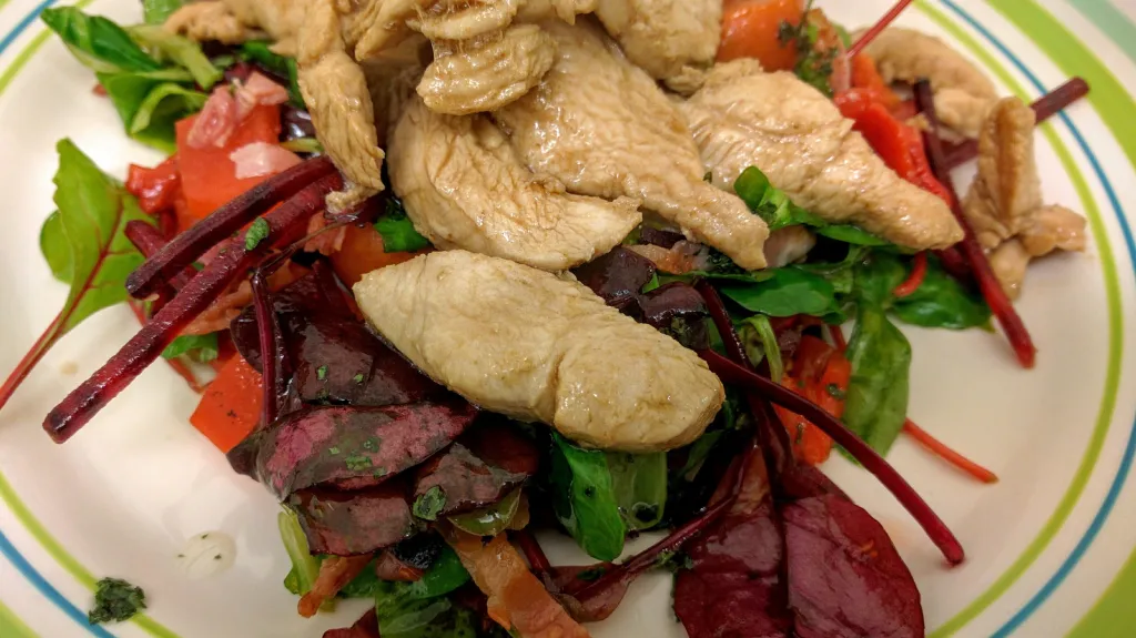 Photograph of Oriental marinated chicken strips with bistro salad.
