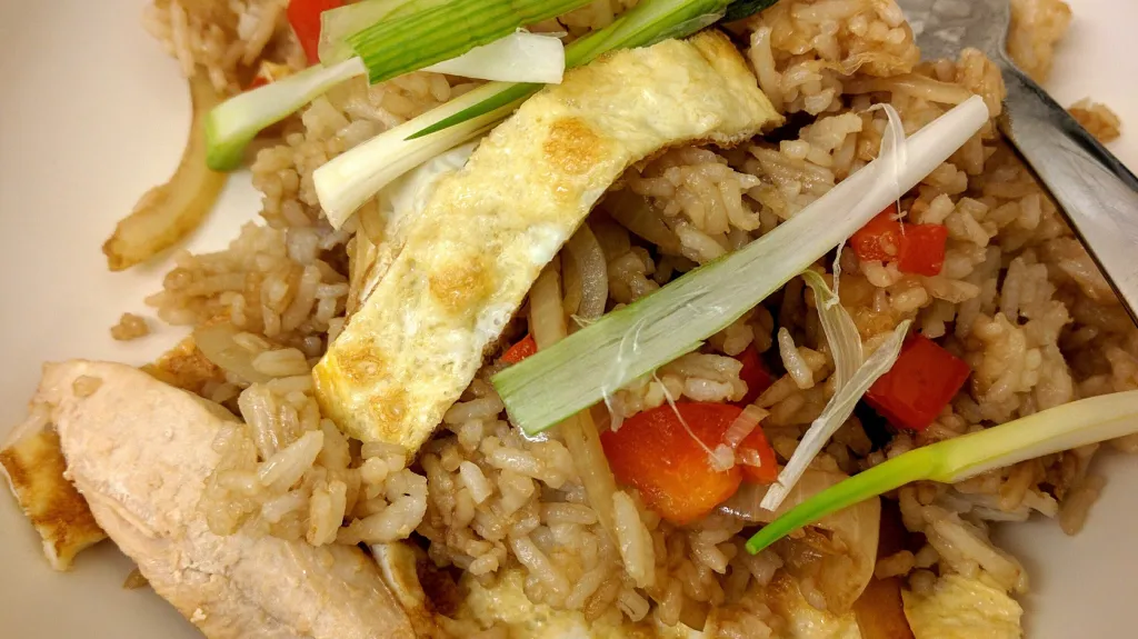 Photograph of Pan roasted chicken with spicy fried rice.