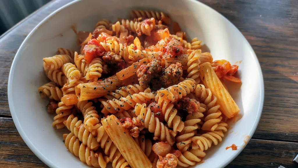 Photograph of Pappardelle with rosemary and sausage ragu.