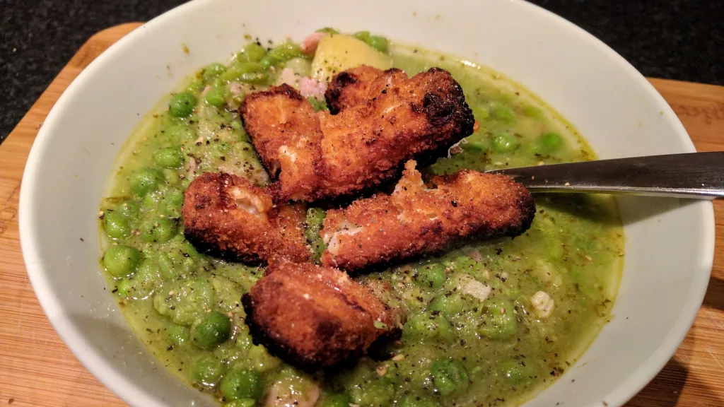Photograph of Pea & pesto soup with fish finger croutons.