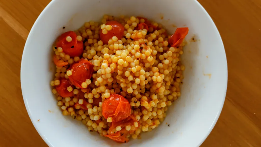 Photograph of Pearl couscous with sauteed cherry tomatoes.