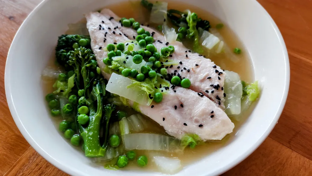 Photograph of Poached fish with ginger & sesame broth.