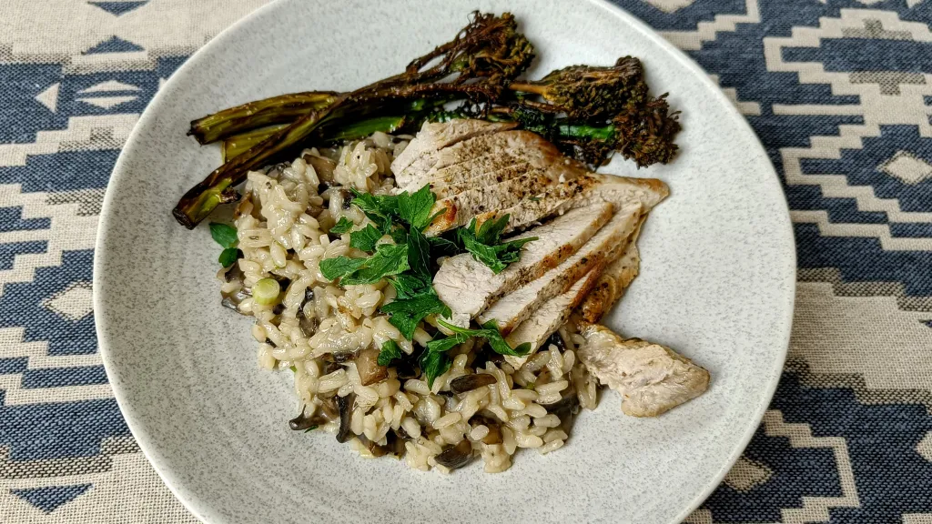 Photograph of Pork chops with mushroom-scallion risotto.