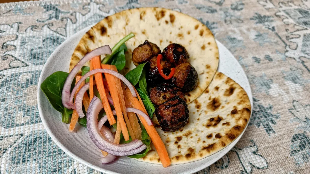 Photograph of Pork, coriander & spring onion meatballs with tamarind glaze.
