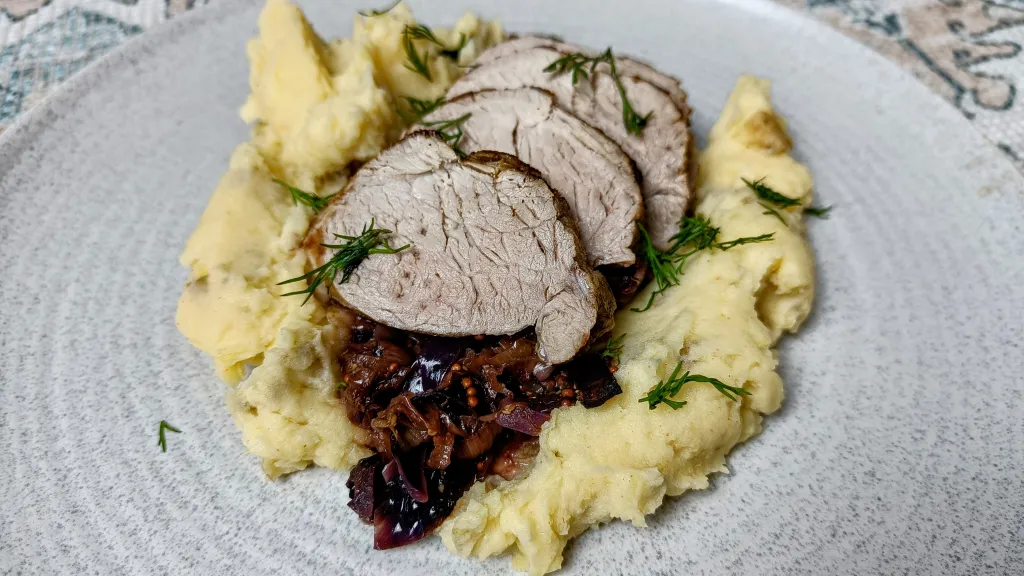 Photograph of Pork tenderloin with cabbage.