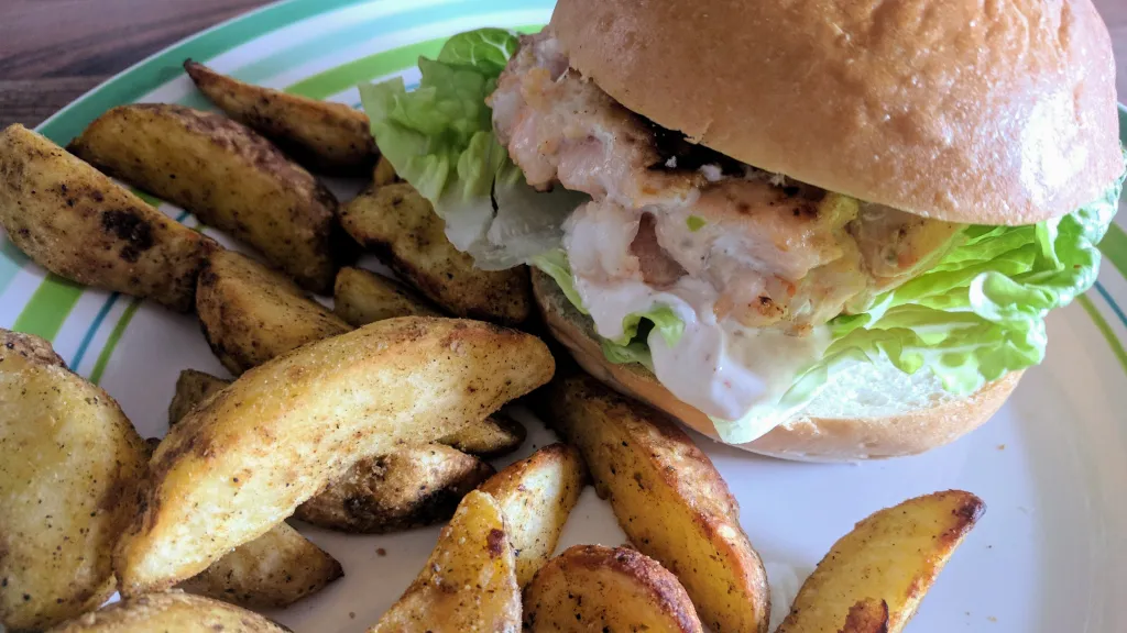Photograph of Prawn & salmon burgers with spicy mayo.