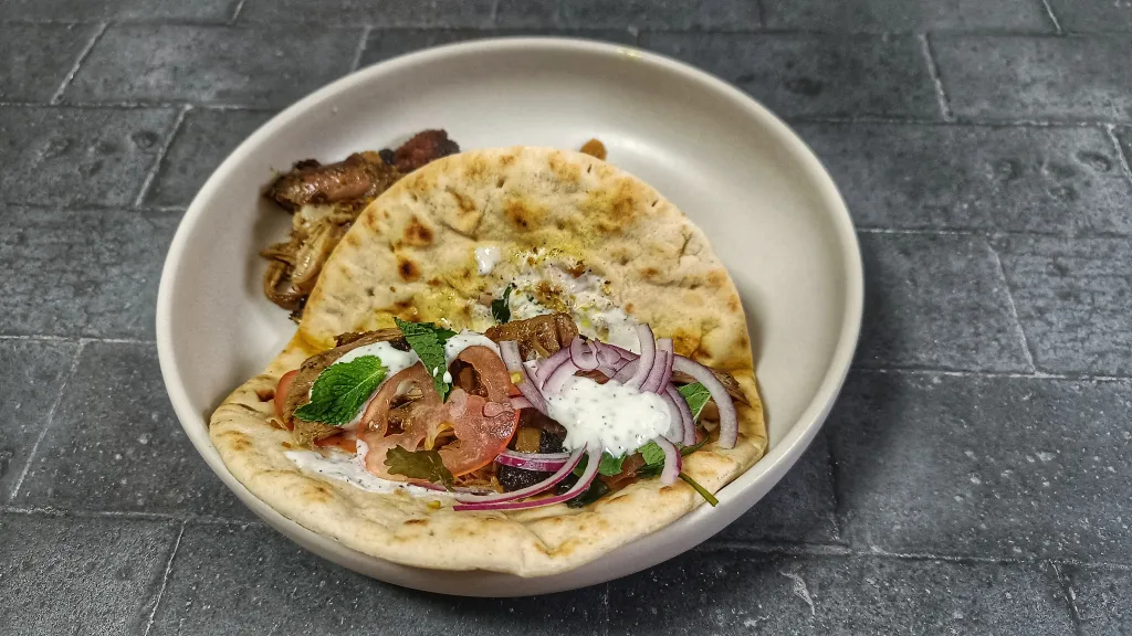 Photograph of Pulled lamb shawarma sandwich.