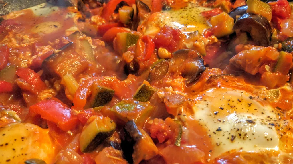 Photograph of Ratatouille with poached eggs.